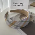 Close-up of thick plaid sponge headband with colorful tweed fabric and suede lining - Purple Yellow Plaid
