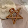 Matte brown star-shaped hair claw clip with cutout design and spring closure - Brown