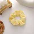 Knitted scrunchie in light yellow cream color with honeycomb texture for hair styling - Yellow