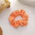 Sweet knitted orange scrunchie hair tie with delicate pleated texture and soft elastic band - Orange