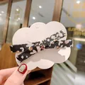 Fermaglio per capelli a fiocco floreale in tessuto nero su carta a nuvola - Nero Floreale
