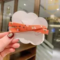 Orange floral bow hair clip with cute cartoon pattern on cloud-shaped display card - Orange Floral