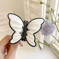 Elegant butterfly hair claw clip with black and white acrylic finish for women - White