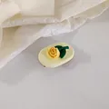 Detailed view of a yellow rose matte resin hair clip on a minimalist white background - Yellow