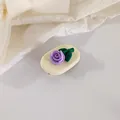 Detail of a purple tulip hair clip with green leaves on cream oval base and silk - Purple
