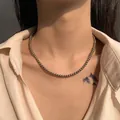 Minimalist metallic bead necklace featuring polished finish beads on a female model - Tahitian Gray Size Four