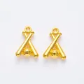 Macro shot of two vintage golden baseball and bat alloy charms for DIY jewelry making - Gold