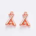 Close-up of rose gold baseball and crossed bats pendants for DIY jewelry making - Rose Gold