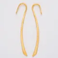 Macro detail of curved long-style gold alloy earring hooks with a matte frosted finish - Gold