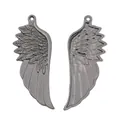 Detailed macro view of vintage zinc alloy angel wing charms with feather textures - Gunmetal