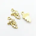 Macro detail of retro gold alloy acorn and oak leaf charms with fine vein textures - Antique Gold