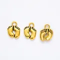 Detailed view of three vintage gold alloy baby feet charms for DIY jewelry making - Antique Gold