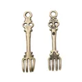 Close-up of vintage bronze spoon and fork charms for DIY jewelry making and crafts - Vintage Fork Style / Antique Bronze