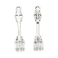 Macro view of vintage silver alloy fork pendants with detailed floral textures and hanging loops - Vintage Fork Style / Antique Silver