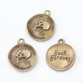 Three vintage bronze skull pendants with circular embossed metal design and hanging rings - Antique Bronze