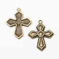 Antique bronze cross charms in vintage style showing front and back embossed textures - Antique Bronze