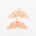 Macro shot of rose gold flower connectors with filigree scrolls for DIY jewelry making - Rose Gold
