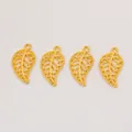 Detailed view of four golden alloy leaf pendants with hollow textures for DIY jewelry making - Gold