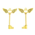 Macro detail of vintage gold alloy wing key charms for DIY jewelry and accessory making - Antique Gold