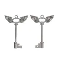 Macro detail of vintage silver alloy wing key pendants for DIY jewelry crafting - Gunmetal