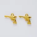 Detailed view of two golden zinc alloy revolver pistol charms for DIY jewelry making - Antique Gold