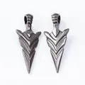 Detailed macro view showing the front and back of vintage arrow alloy pendants - Gunmetal