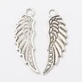 Silver vintage wing pendant charms with detailed feather texture on white background - Antique Silver