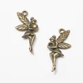 Pair of vintage bronze fairy angel charms with detailed wing textures and hanging loops - Antique Bronze