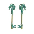 Detail of vintage bronze seahorse key charms with antique patina and intricate metal texture - Antique Green