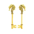 Macro detail of vintage gold seahorse-shaped key pendants with intricate carvings - Antique Gold
