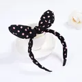 Close-up of cute black fabric bunny ear headband with pink polka dots on white background - Navy Pink Polka Dot