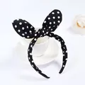 Cute black fabric headband with white polka dots and bunny ears on a white coffee cup - Black And White Spots