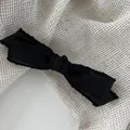 Elegant black bow hair clip with lace edges on creamy textured fabric background - Black / Duckbill Clip