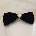 Close-up of black velvet bow hair clip with oval faux gemstone and small pearls - Velvet Bow With Faux Pearl / Black Pearl