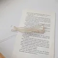 Elegant matte cream ponytail hair clip presented on a vintage book page backdrop - Beige