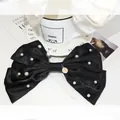 Elegant large black satin hair bow with scattered pearls and a golden metal charm accessory - Oversized Pearl Bow Coin Pendant / Black