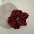 Detail of red tweed scrunchie with metallic fibers on grey stone accessory stand - Black and Red Plaid Scrunchie