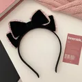Detail of a large double-layer black velvet bow headband with delicate pink ruffled edges - Black Pink Ruffle Edge Headband