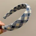 Close-up of handmade plaid headband with blue and beige woven texture for women - Blue Plaid