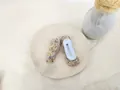 Detailed view of beige crochet hair clips with colorful knit balls and metal duckbill clips - Duckbill Hair Clips / Milky White