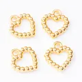 Detailed view of four hollow heart-shaped gold alloy pendants for DIY jewelry making - Gold