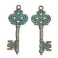 Detail of vintage bronze alloy key pendants with verdigris finish and cross design - Antique Green