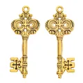Close-up of vintage gold alloy key charms with cross relief for DIY jewelry crafts - Antique Gold