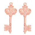 Detailed close-up of rose gold vintage key charms with ornate carvings and textured finish - Rose Gold