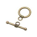Detailed close-up of vintage bronze alloy toggle clasp with textured spiral pattern - Antique Bronze