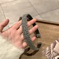 Close-up of gray chunky knit headband showing thick woven texture and soft wool fabric - Gray