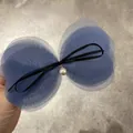 Detail of blue tulle multi-layer bow hair clip with black ribbon and white pearl pendant - Blue