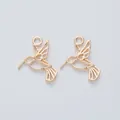 Detail view of two light gold hummingbird alloy pendants with intricate hollow design - KC Gold