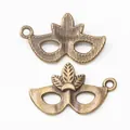 Vintage bronze mask charms for jewelry making with front and back detail views - Antique Bronze