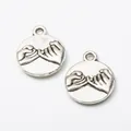 Vintage silver alloy round pendant featuring embossed pinky swear design on white background - Antique Silver